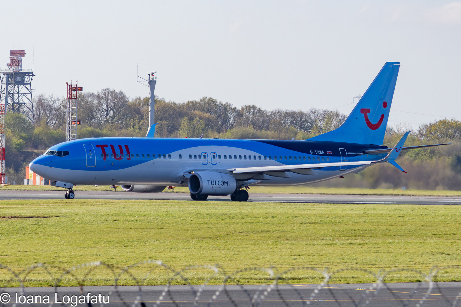 Colorful airplane taxis on bright runway in spring